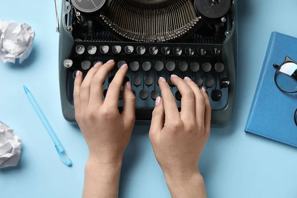 Vrouw Typend Schrijfmachine Met Verfrommeld Papier Notitieboekje Bril Lichtblauwe Achtergrond — Stockfoto