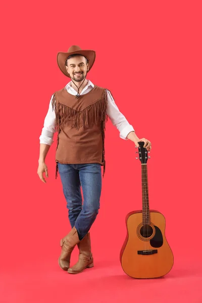 Schöner Cowboy Spielt Gitarre Auf Rotem Hintergrund — Stockfoto