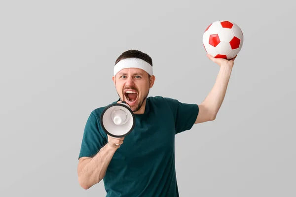 Emotional Man Soccer Ball Megaphone Light Background — Stock Photo, Image