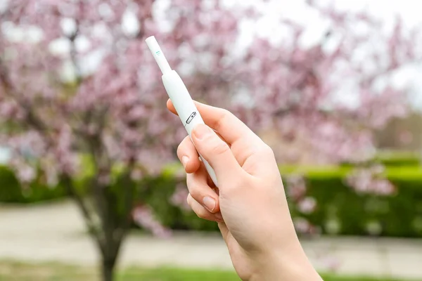 stock image Female hand holding modern electronic cigar outdoors