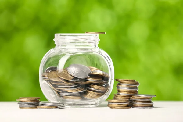 Jar Coins Table Blurred Green Nature Background Savings Concept — Stock Photo, Image