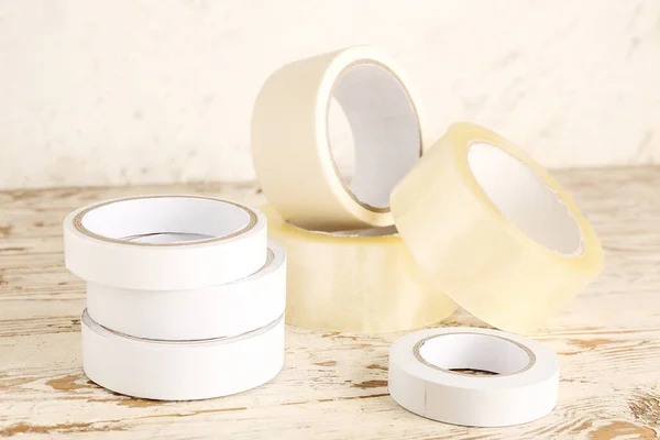 stock image Adhesive tape rolls on light wooden table