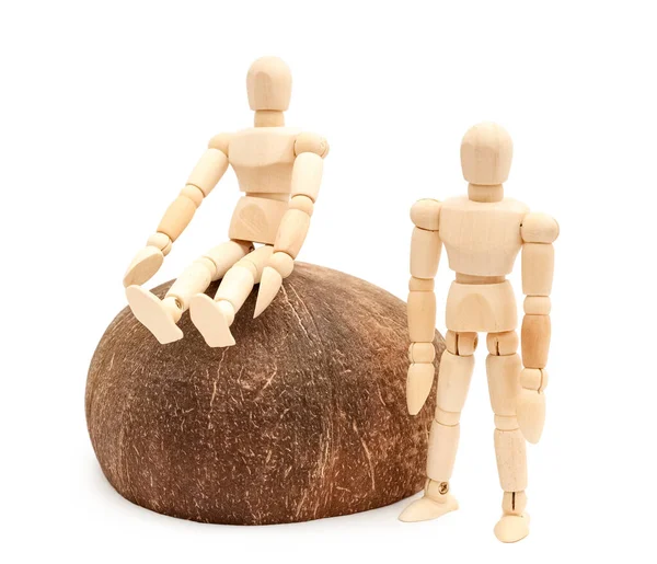 Wooden mannequins with coconut on white background