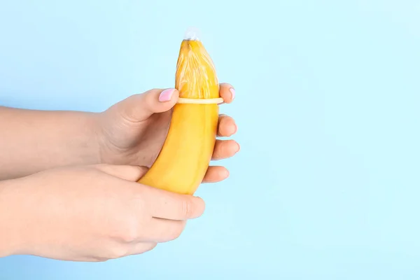 Woman Putting Condom Banana Blue Background Sex Concept — Stock Photo, Image
