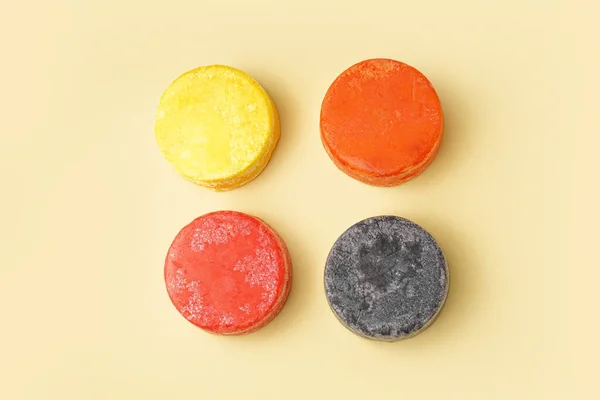 Solid shampoo bars on yellow background