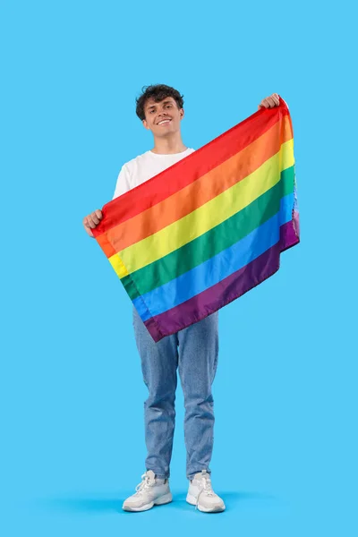 Młody Człowiek Flagą Lgbt Niebieskim Tle — Zdjęcie stockowe