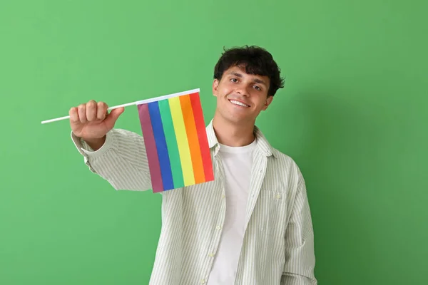 緑の背景にLgbtの旗を持つ若い男 — ストック写真