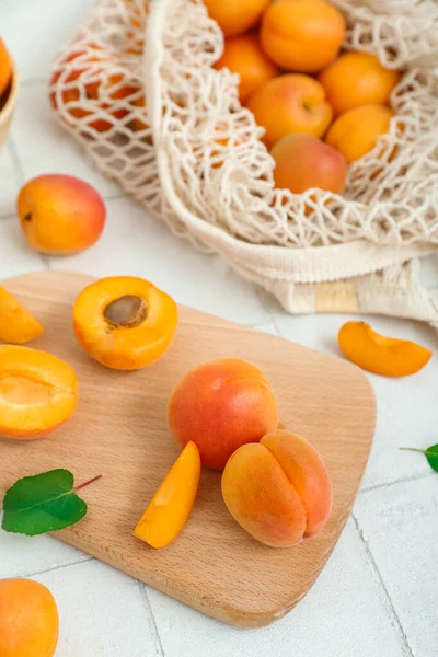 Board String Bag Fresh Apricots White Tile Table — Stock Photo, Image