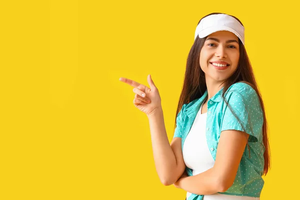 Young Woman Cap Pointing Something Yellow Background — Stock Photo, Image