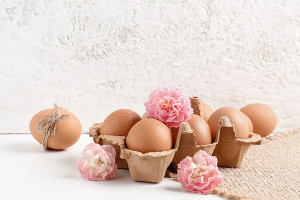 Package Easter Eggs Carnation Flowers Table White Grunge Wall — Stok fotoğraf