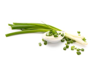 Beyaz arka planda dilimlenmiş yeşil soğanlı lezzetli ekşi krema teknesi.