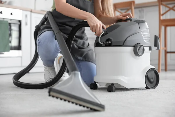 Male worker removing dirty stain from grey sofa with vacuum cleaner in room  Stock Photo - Alamy