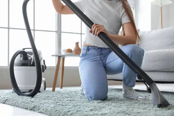 Young Woman Vacuuming Carpet Home — Foto de Stock
