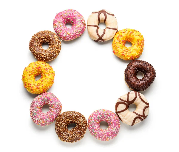 Frame made of sweet donuts on white background