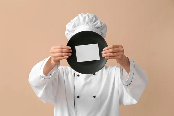 Female Chef Holding Plate Blank Card Beige Background — Stock Photo, Image