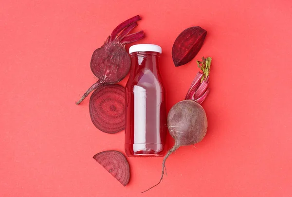 stock image Bottle of healthy beet juice on red background