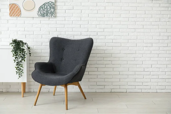 Dark Grey Armchair Dresser Painting Houseplant White Brick Wall — Stock Photo, Image