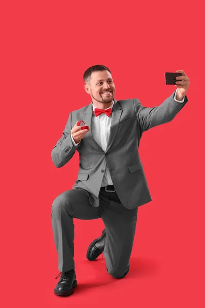 Όμορφος Άντρας Δαχτυλίδι Αρραβώνων Που Βγάζει Selfie Κόκκινο Φόντο — Φωτογραφία Αρχείου