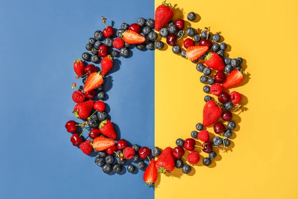 stock image Frame made of different fresh berries on colorful background