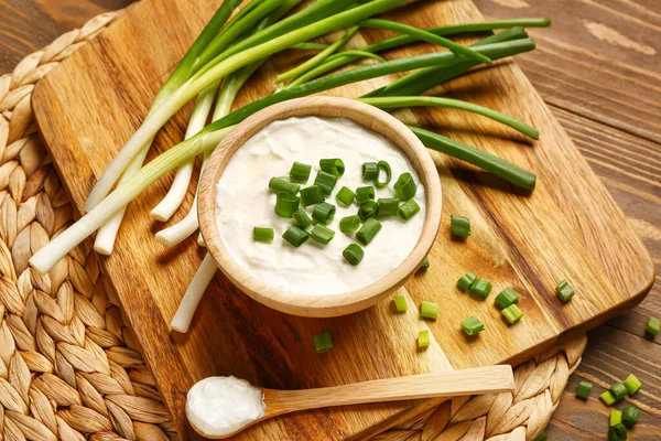 Board Bowl Tasty Sour Cream Sliced Green Onion Wooden Background — Stock Photo, Image