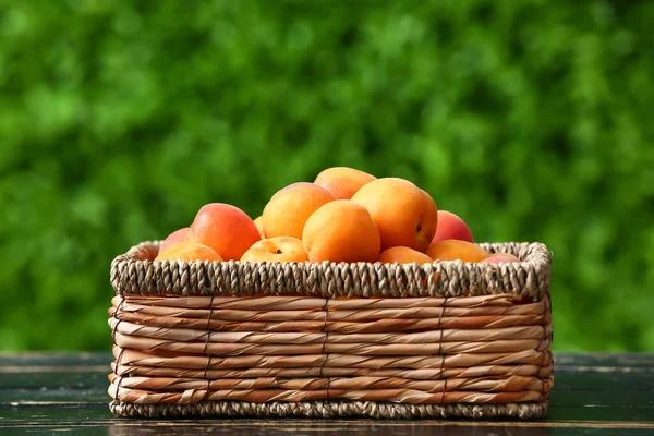 Wicker Box Fresh Apricots Black Wooden Table Outdoors — Stock Photo, Image
