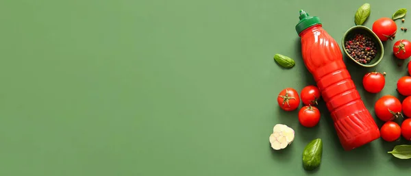 stock image Bottle of ketchup, spices and tomatoes on green background with space for text