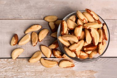 Hafif ahşap arka planda bir kase lezzetli Brezilya fındığı