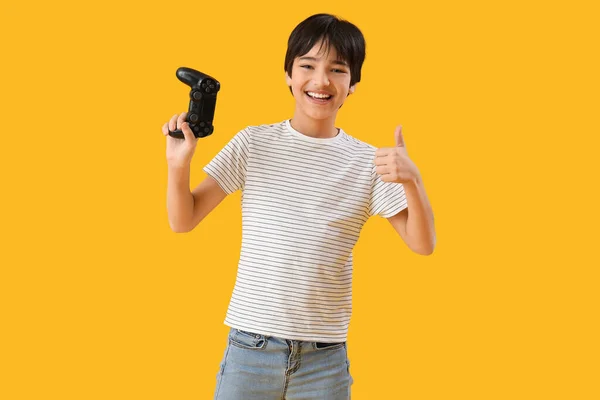 Little Boy Game Pad Showing Thumb Yellow Background — Stock Photo, Image