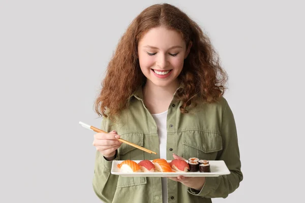 Young Woman Sushi Light Background — Stock Photo, Image
