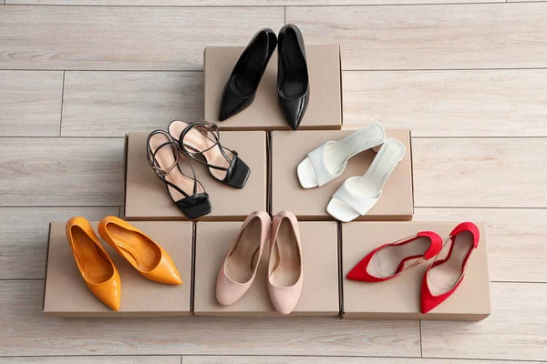 Cardboard Boxes Different Colorful High Heeled Shoes Light Wooden Background — Stock Photo, Image