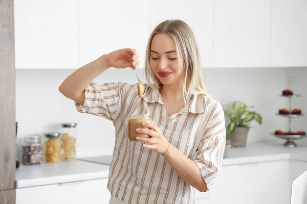Young Woman Spoon Jar Nut Butter Kitchen — Stock Photo, Image