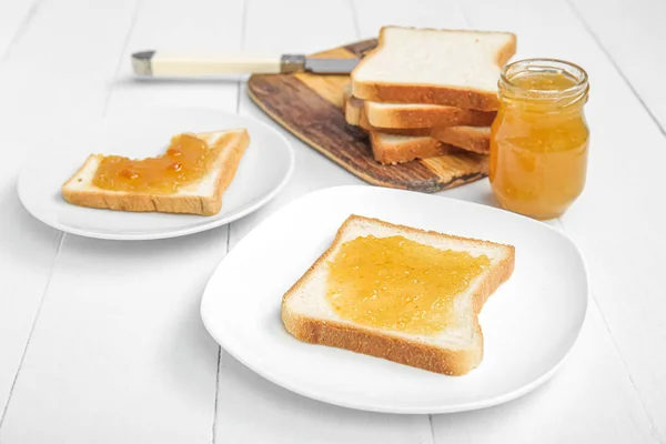 Board Plates Tasty Toasts Apricot Jam Knife White Wooden Background — Stock Photo, Image