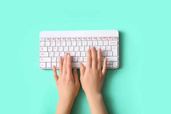 蓝绿色背景的现代计算机键盘的女性手 — 图库照片