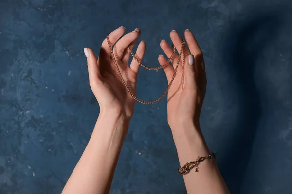 Woman Bracelet Holding Beautiful Golden Necklace Grunge Blue Background — Stock Photo, Image