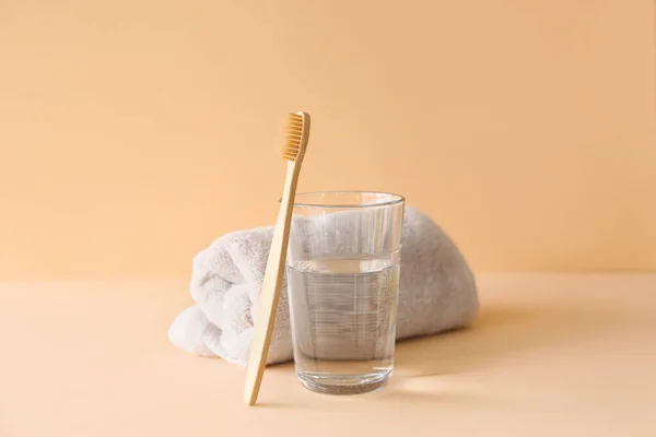 Bamboo Tooth Brush Glass Water Towel Beige Background — Stock Photo, Image