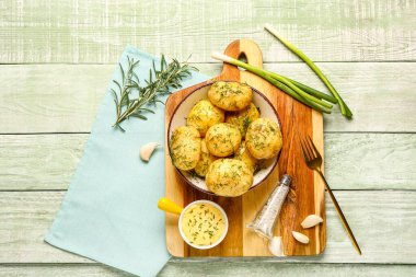 Yeşil ahşap arka planda dereotlu haşlanmış bebek patatesler.