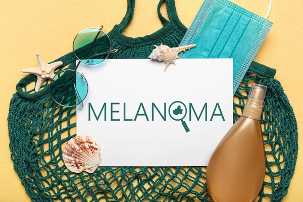 Banner with beach accessories and word MELANOMA