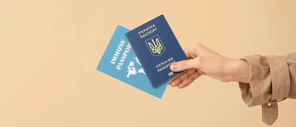 Mano Femenina Con Pasaportes Ucranianos Inmunes Sobre Fondo Beige Con —  Fotos de Stock