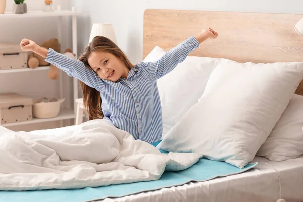 Little Girl Stretching Electric Heating Pad Bedroom — Stock Photo, Image