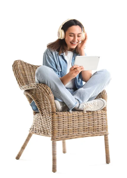 Young Woman Headphones Using Tablet Computer Wicker Armchair White Background — Stock Photo, Image
