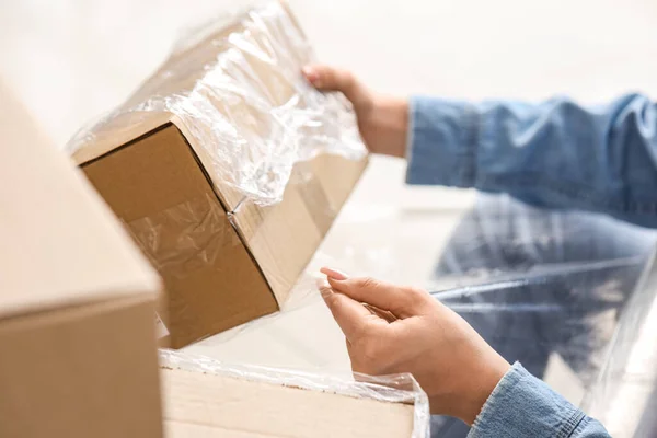 Young Woman Wrapping Cardboard Box Stretch Film Home Moving Day — Stock Photo, Image