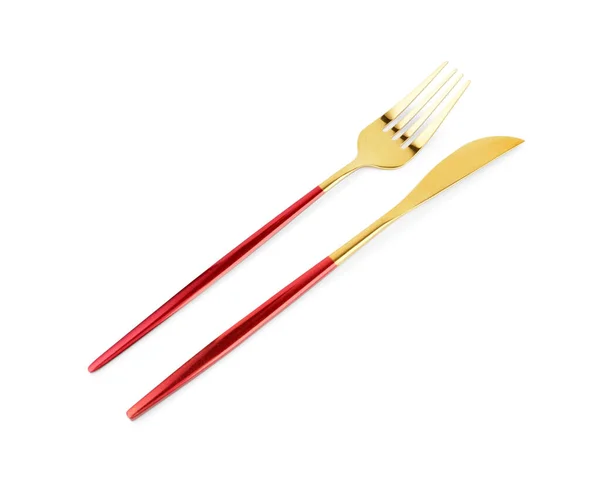 白い背景に赤いハンドルを持つ黄金のフォークとナイフ — ストック写真