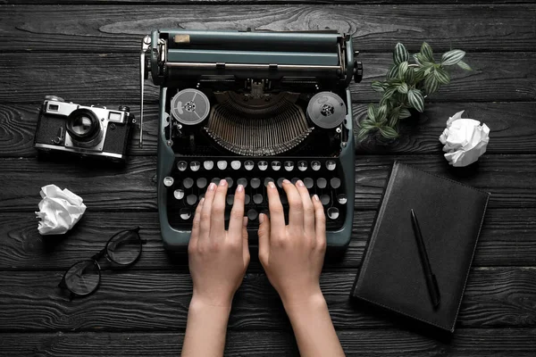 Woman Typing Typewriter Camera Eyeglasses Crumpled Paper Black Wooden Background — Stock Photo, Image