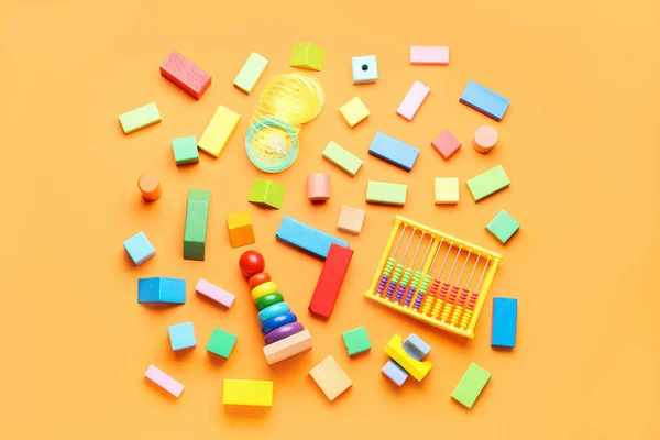 Different colorful toys on orange background. Children\'s Day celebration