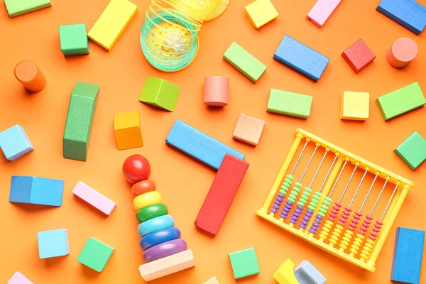 Verschiedene Bunte Spielzeuge Auf Orangenem Hintergrund Kindertagsfeier — Stockfoto