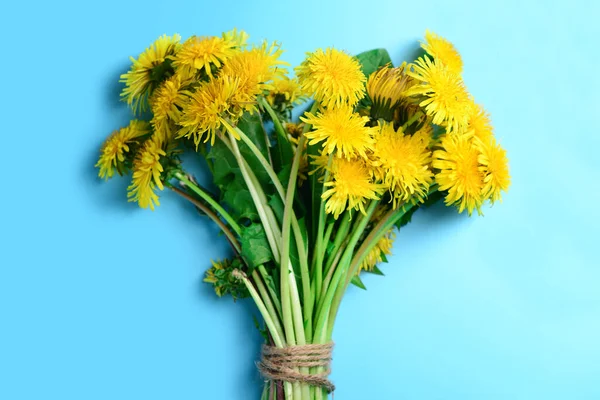 Bouquet of yellow dandelion flowers on color background, closeup