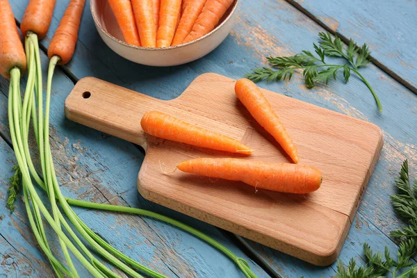 Board Bowl Fresh Carrots Blue Wooden Background — Stock Photo, Image