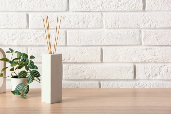 Bottle Reed Diffuser Houseplant Table Light Brick Wall Room — Stock Photo, Image