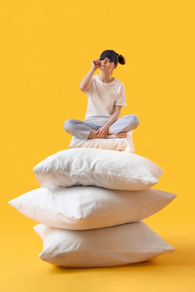 Young Woman Sleeping Mask Soft Pillows Sitting Yellow Background — Stock fotografie