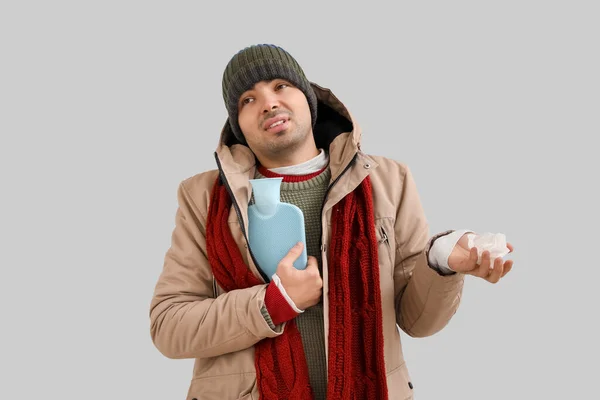 Ill Young Man Hot Water Bottle Tissue Grey Background — Fotografia de Stock